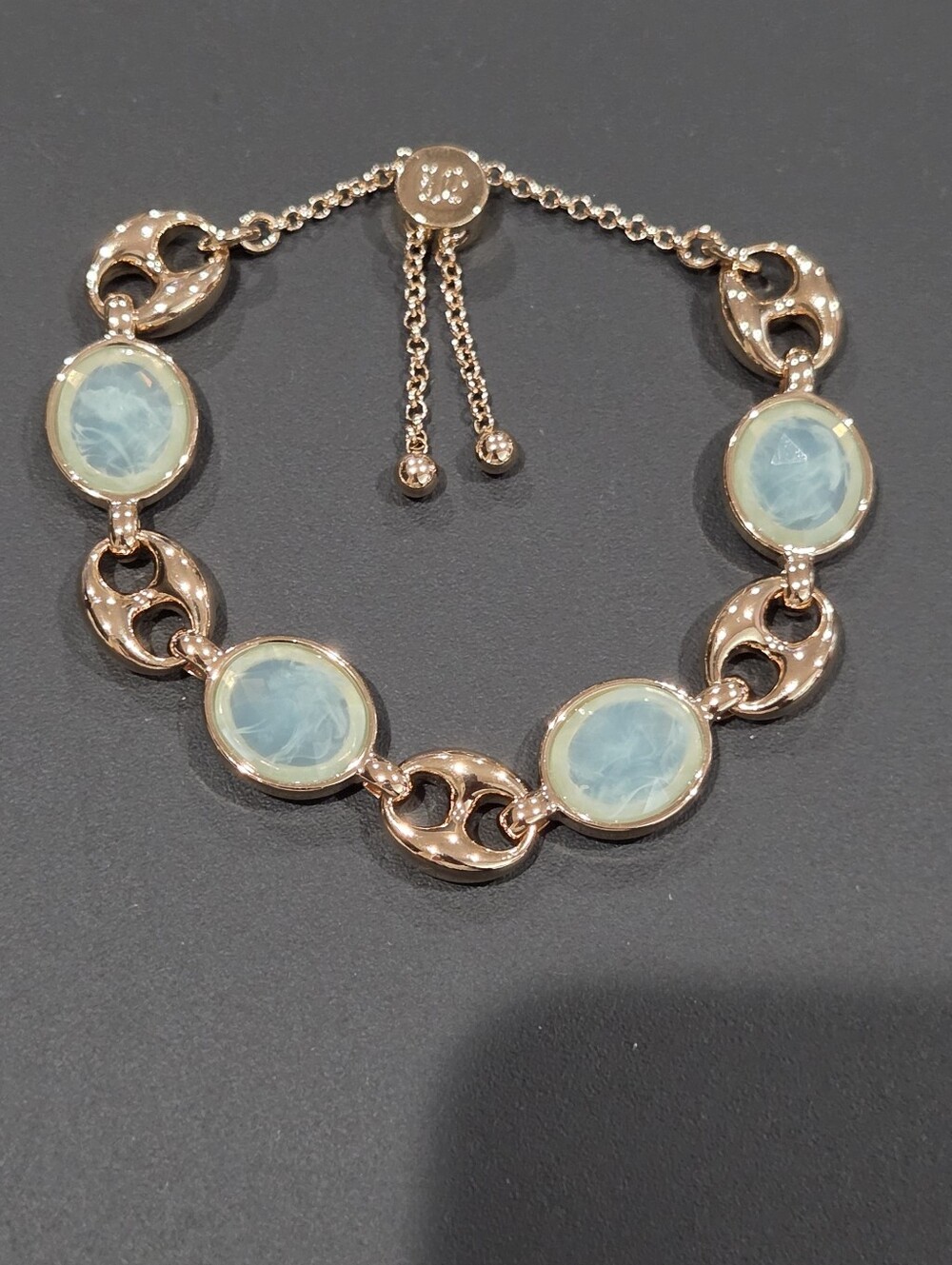Elegant rose gold Bomb Party bracelet featuring five light blue gemstones